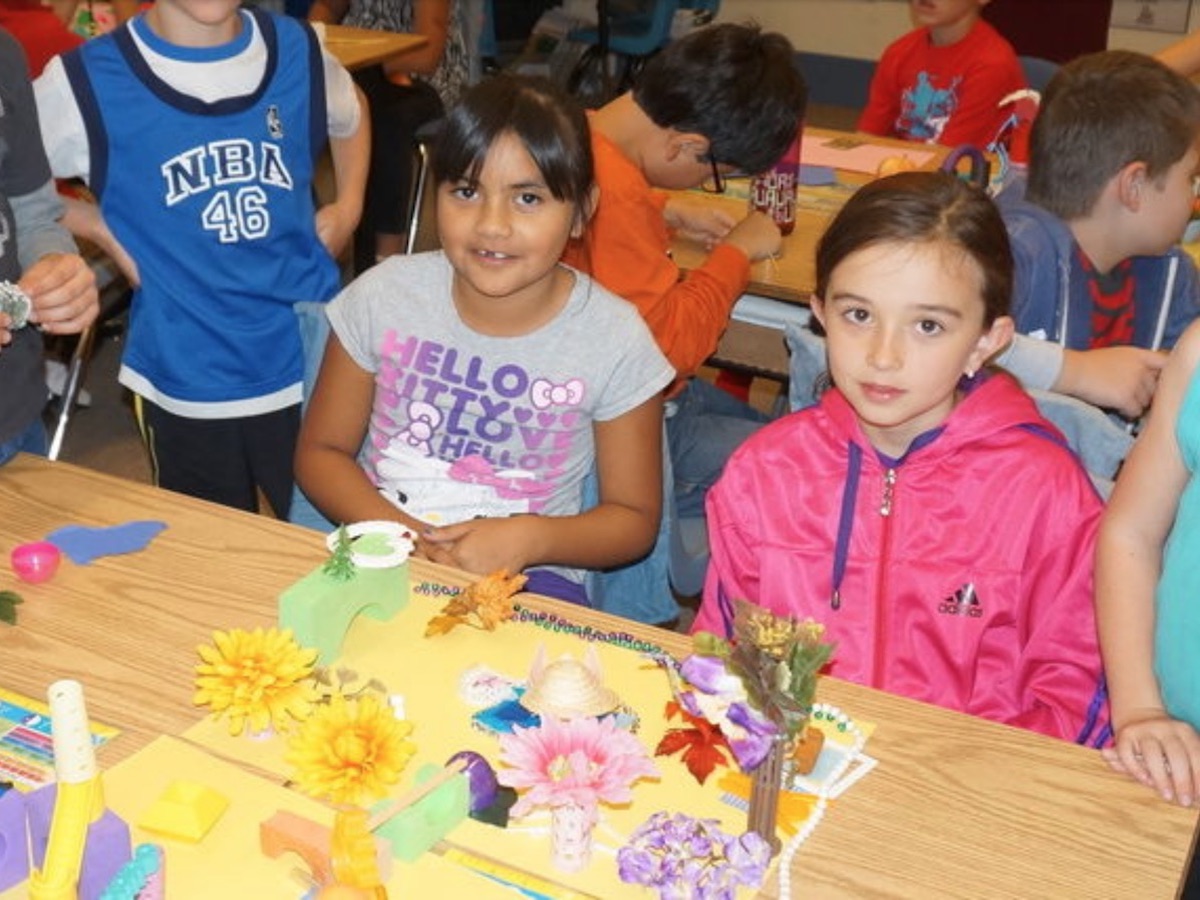 Photo of engaging kids in urban planning through play and model-building.