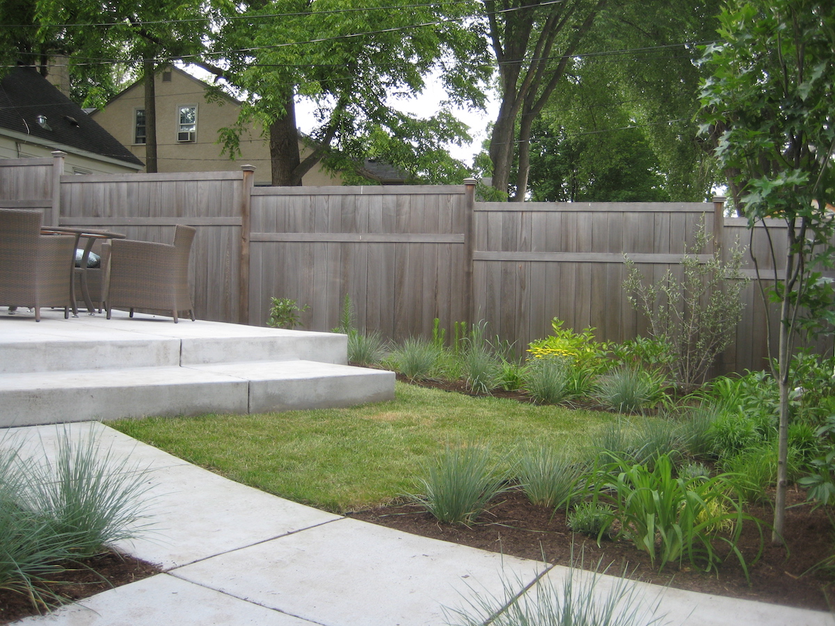 The modern patio and surrounding plantings in the back portion of the Swoosh landscape.
