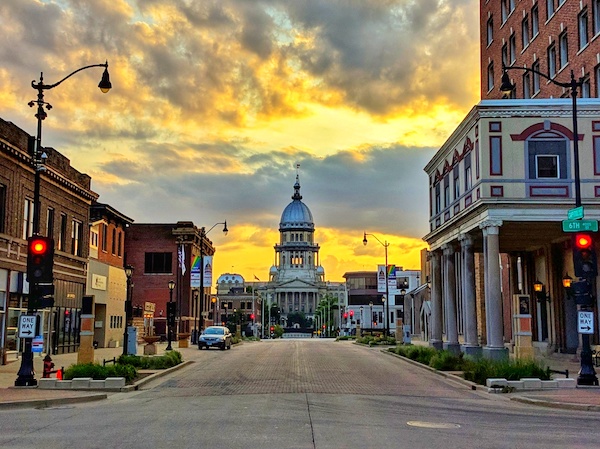 A photo of downtown Springfield, Illinois, with the State Capitol in the background